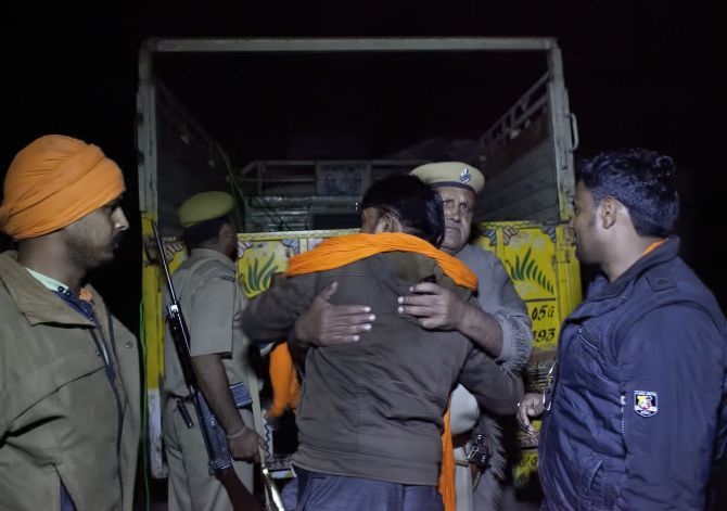 A policeman hugs a gau rakshak after the gau rakshaks chased down a truck that was smuggling cows in Ramgarh, Rajasthan. Photograph: Allison Joyce/Getty Images