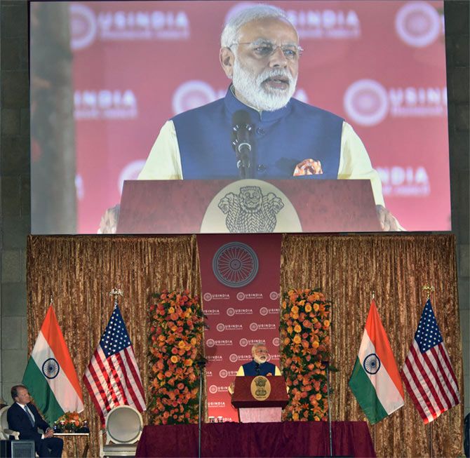 Cisco Chairman John Chambers watches Prime Minister Narendra Modi address the US-India Business Council's 40th annual general meeting, Washington, DC, June 7, 2016.