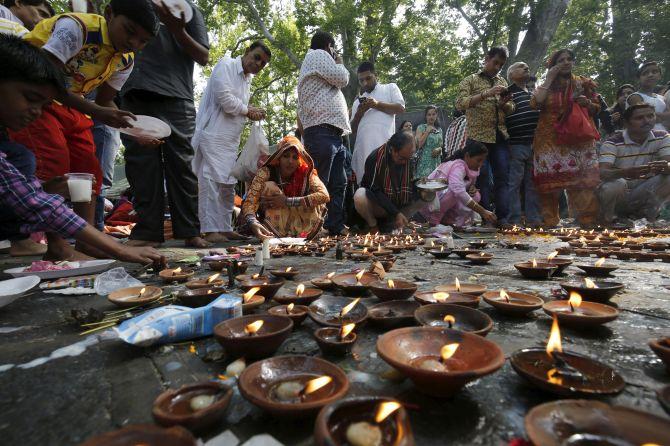 Lighting oil lamps in a temple