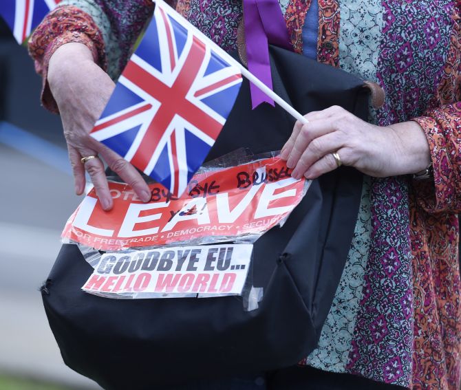 Image: A vote leave supporter holds a poster in Westminster, London. Photograph: Toby Melville/Reuters