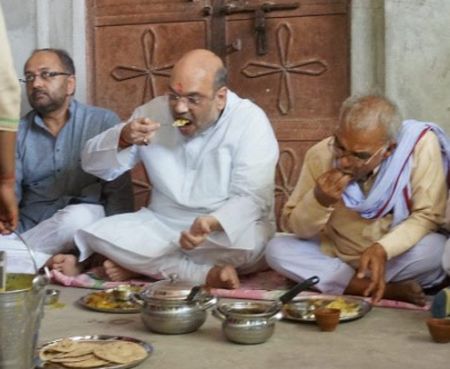 Bharatiya Janata Party President Amit Shah had a meal with a Dalit family in Jogiyapur village in the Sevapuri assembly segment in Prime Minister Narendra Modi's Varanasi Lok Sabha constituency, June 2016.