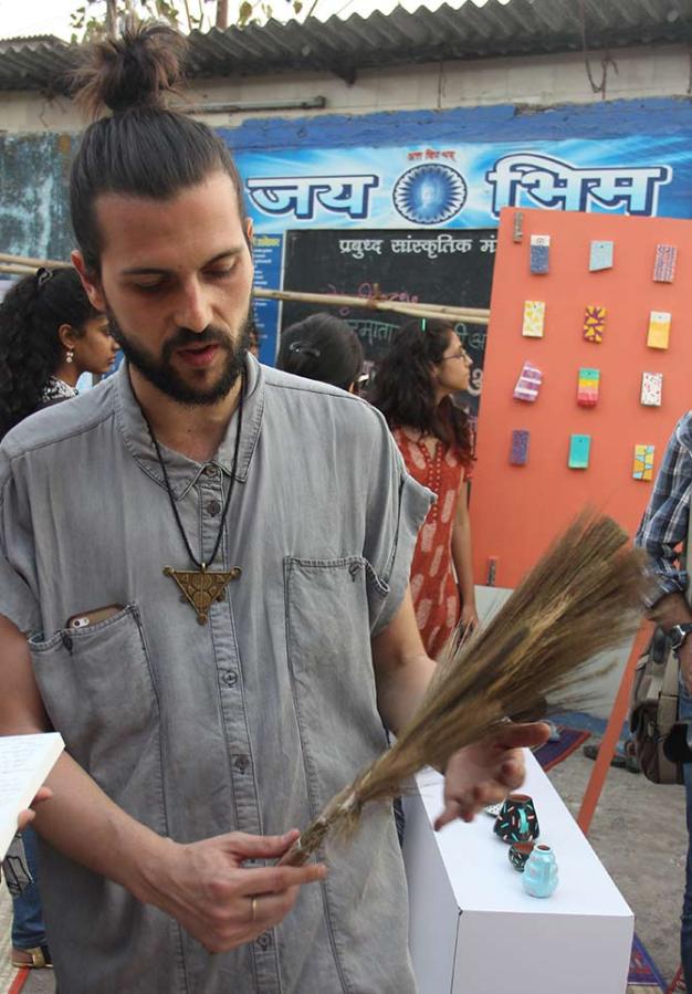 Rubio with a broom at the Design Museum Dharavi.