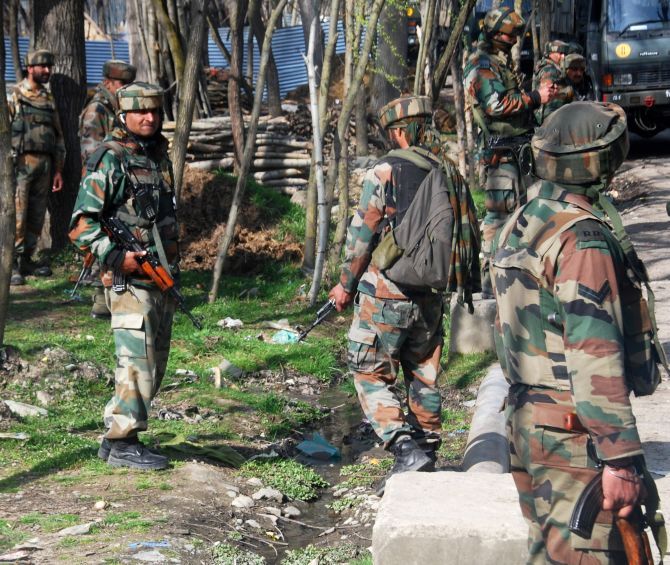 Soldiers conduct a search in the aftermath of a fierce gunfight between soldiers and terrorists in south Kashmir's Pulwama district, March 9, 2016. Two terrorists were killed. Photograph: Umar Ganie