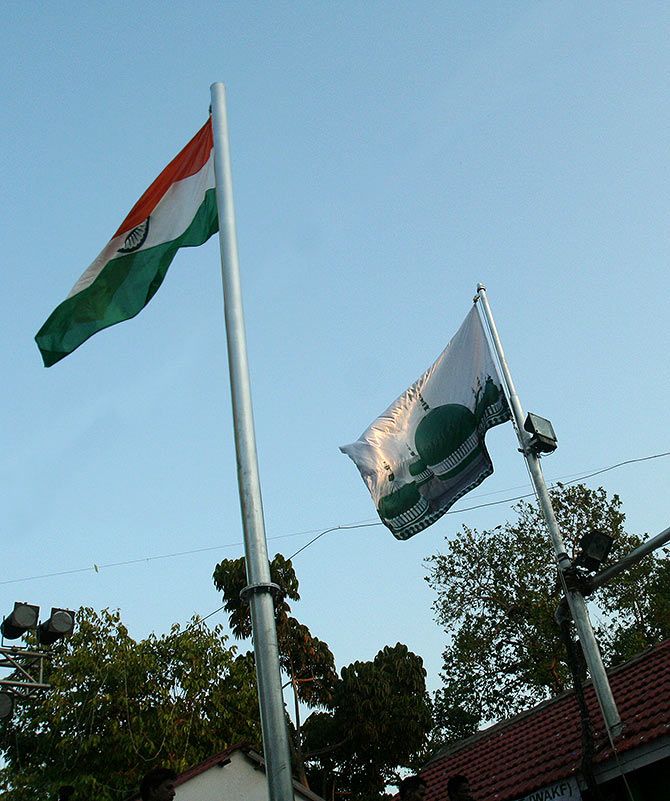The Indian tricolour and the flag of the Peer Makhdum Shah Baba fly next to each other at the Peer Makhdum Shah Baba dargah.