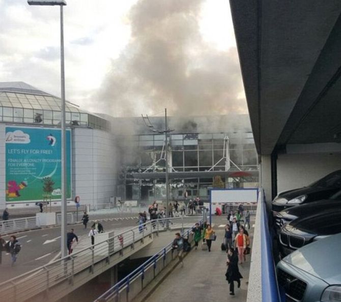 People flee Brussels airport after the terror attack.