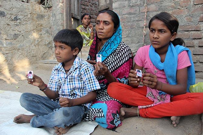 Ashabai with her youngest son Mahesh and daughter Pushpa outside her brother's house in Vida village, Kej taluka, Beed district, Maharashtra. Her son Sachin, 9, drowned while fetching water from a well located about a kilometre from their house.