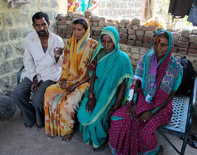 IMAGE: Ashok Desai, his wife with her mother-in-law in a green sari and her mother in a pink sari outside the Desais' home in Sabalkhed village, Ashti taluka, Beed 