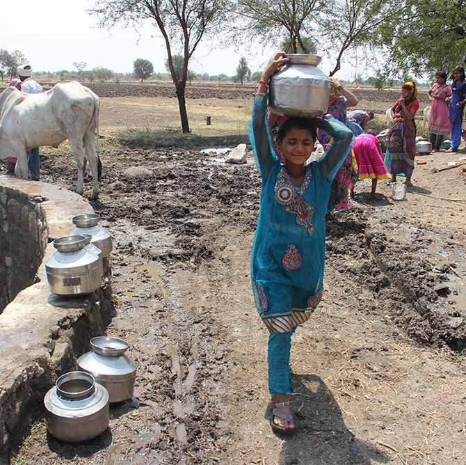 A child collects water in drought hit Maharashtra.