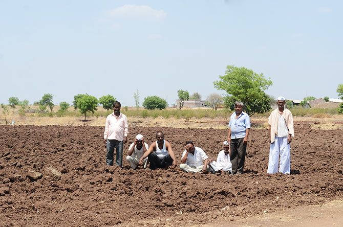 IMAGE: From left: Shahdev Gopinath Bhoge, Shaikh Ismail, Vishnu Mahadev Norude, Atmaram Mule and Pandurang Shingire with two other farmers; In a parody of sorts, Norude asked Mule to strike a pensive pose for this picture. Mule quickly put his hand to his forehead to look like a distressed farmer. Even under a hot sun and a searing drought these farmers were a jovial lot