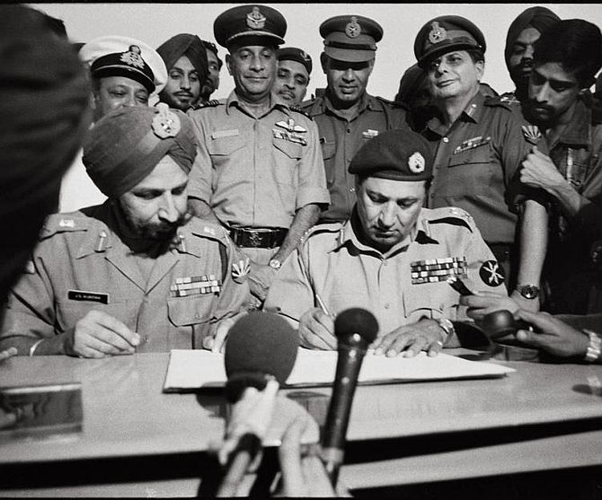 The most famous photograph in Indian military history! Lieutenant General A A K Niazi, the Pakistan army commander in East Pakistan, signs the Instrument of Surrender, before Lieutenant General Jagjit Singh Aurora, General Officer Commanding in Chief, Eastern Command, December 16, 1971. Photograph: DPR Photo Division Archives
