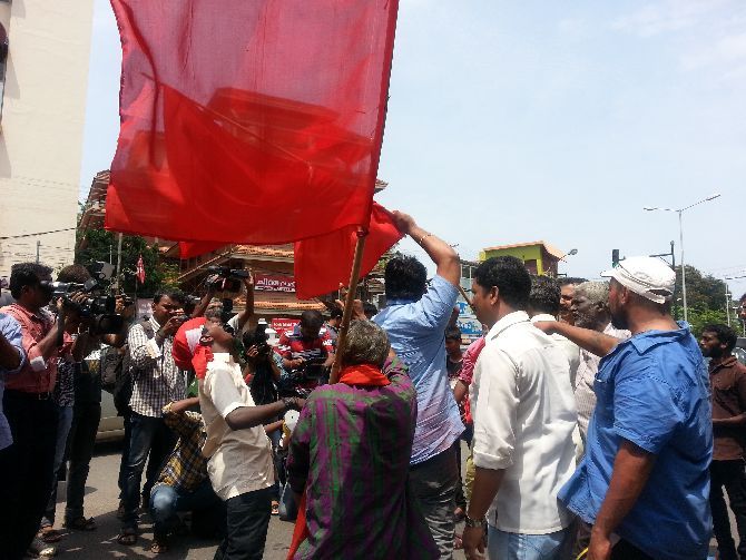 Activists celebrate outside the CPI-M office in Thiruvanantapuram