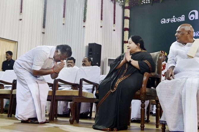 O Panneerselvam bows before J Jayalalithaa as then Tamil Nadu governor K Rosaiah looks on.