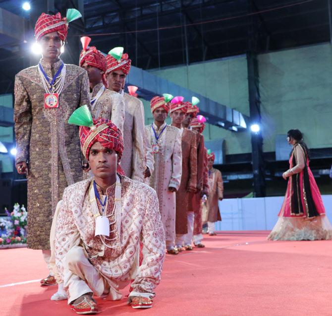 The grooms make their way to the stage.