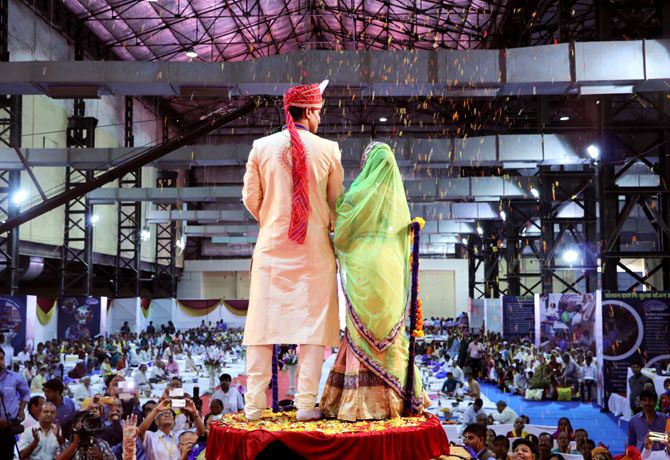 The first couple to get married seek blessings from the crowd.