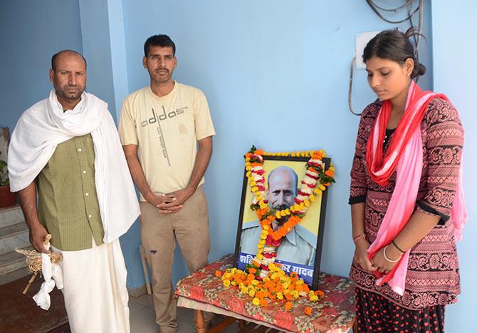 From left: Shambhunath Yadav, Prabhunath and Soniya outside their home in Bhopal's Sanjiv Nagar