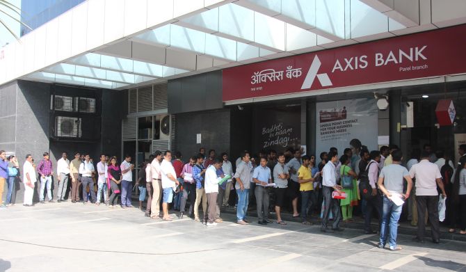 People queue up for money outside a bank