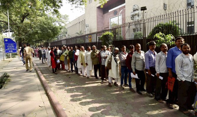 People queue up for money outside a bank