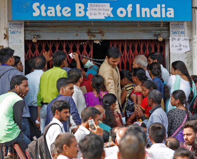 People queue up for money outside a bank