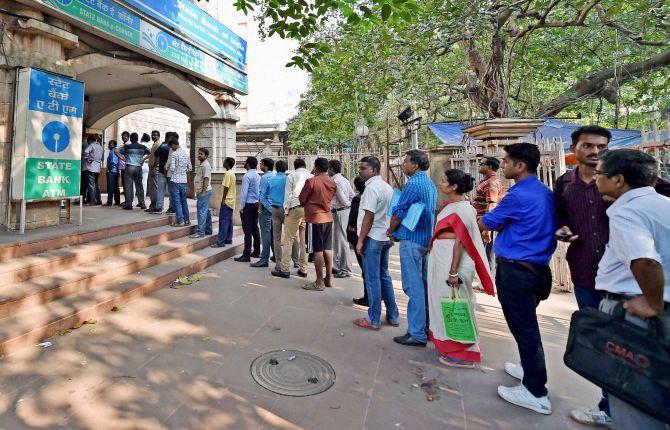 People queue up for money outside a bank