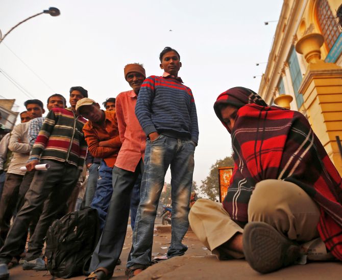 A queue outside a bank in the early hours of the morning in New Delhi. Photograph: Adnan Abidi/Reuters