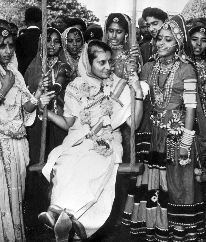 Indira Gandhi surrounded by folk dancers from Rajasthan at her home in New Delhi in 1967. Photograph: Express/Getty Images