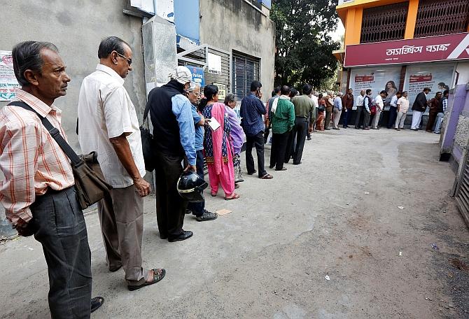 People queue up for money outside a bank