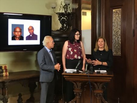 Abuse victim Megan Peterson, centre, at a press conference in Minnesota. On the blackboard are images of the accused Joseph Jeyapaul