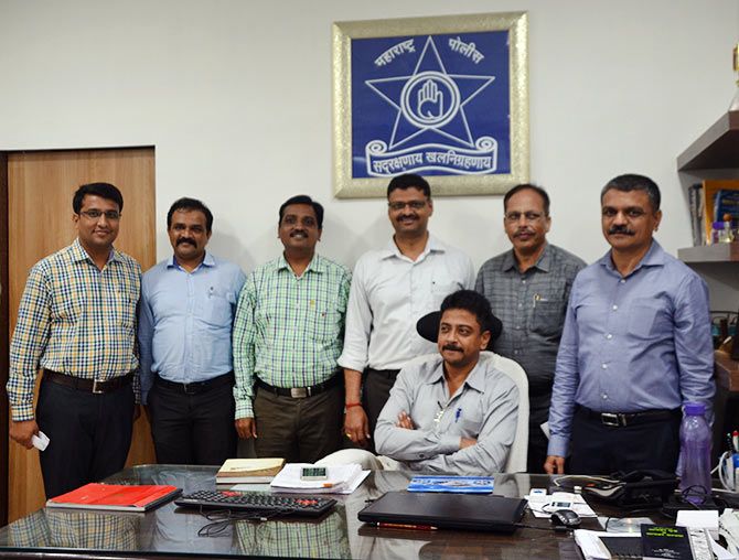 Senior police inspector, Unit 1, Nitin Thakare (extreme right in blue shirt), Assistant Commissioner of Police (Detection) Mukund Hatote (seated) along with members of the Thane Crime Branch team that busted the scam