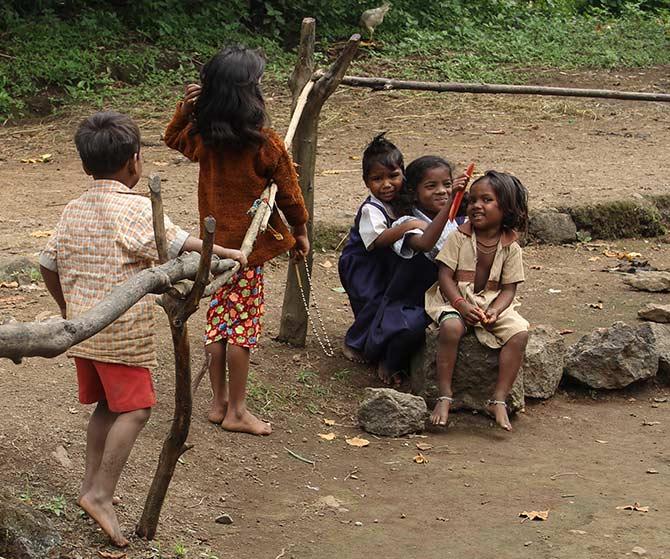 Mostly children can be found inside the anganwadi only when food is served to them. After eating their morning breakfast these children spend some leisurely moments with this girl braiding her friend's hair. 