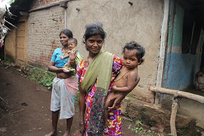 The anganwadi had served the 9 am breakfast of nutritious laddoos to the children and their mothers. Around 10.30 am the children and their mothers had left for their homes to do their routine work. They would be back by 12.30 pm for lunch. Seen in this photograph is a young mother with her child. Behind her is another mother with her malnourished child.