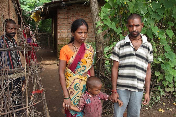 Namdev with his son Krushna, 4.5 years, and his wife Sunder outside their home in Khoch, Mokhada. His eldest daughter Sonali had been to a primary school nearby. 