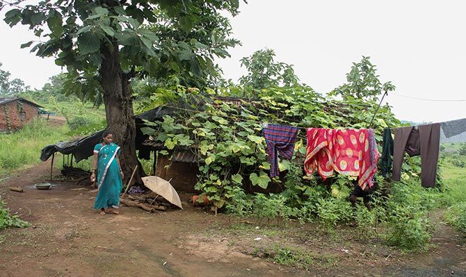 Mamta, outside her ramshackle hut in Pethranjani village, Mokhada, which is wellc-onnected with roads to Mumbai. Despite better connectivity the couple's annual earnings fluctuate between Rs 9000-13,500, which we spend these days to buy a smartphone.