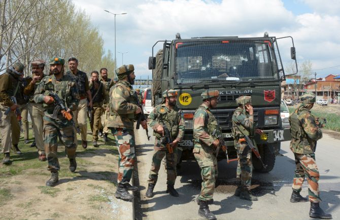 Soldiers cordon off an area after their convoy was attacked by terrorists in Srinagar