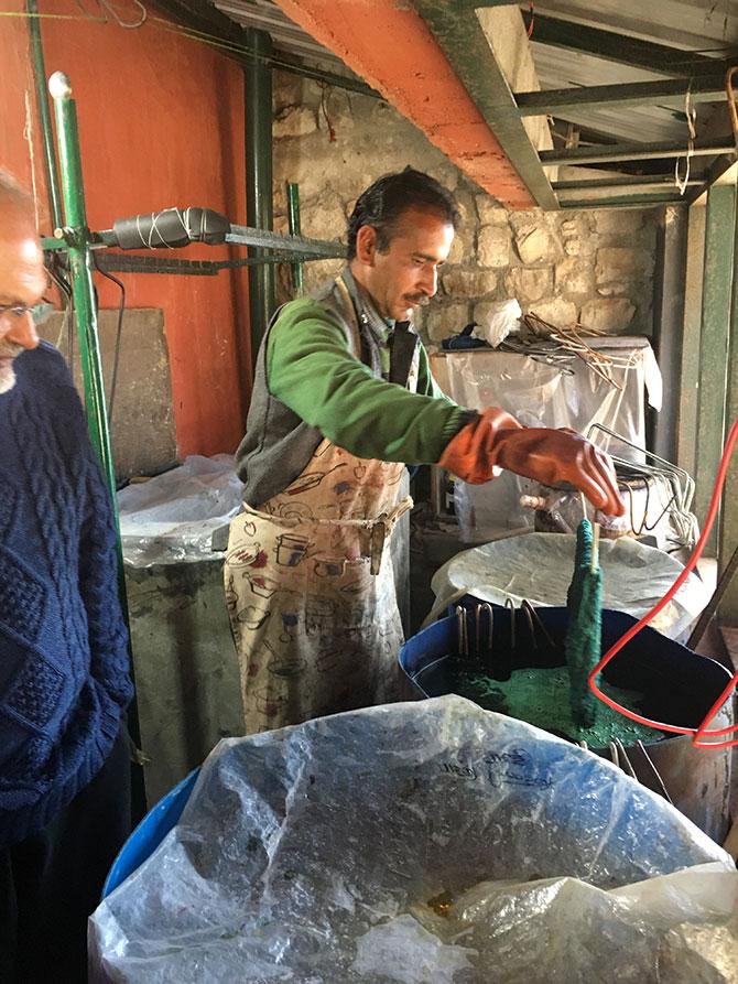 Makkhan dyes wool in the small room