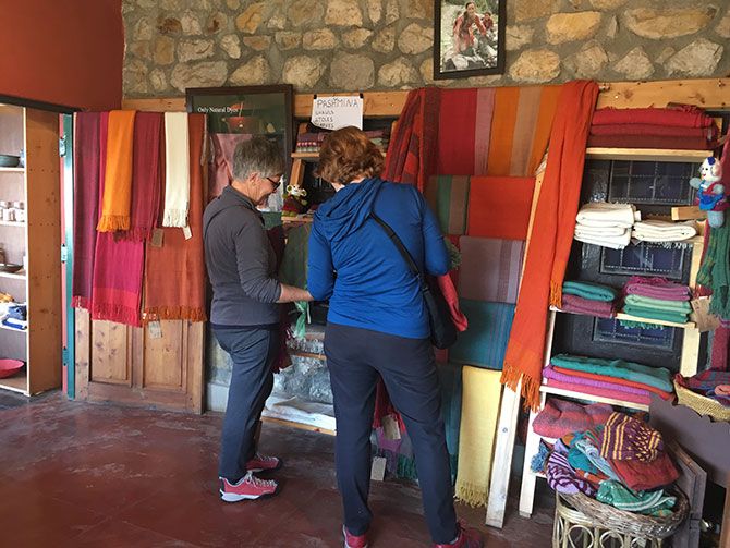Hand-woven shawls displayed in the shop