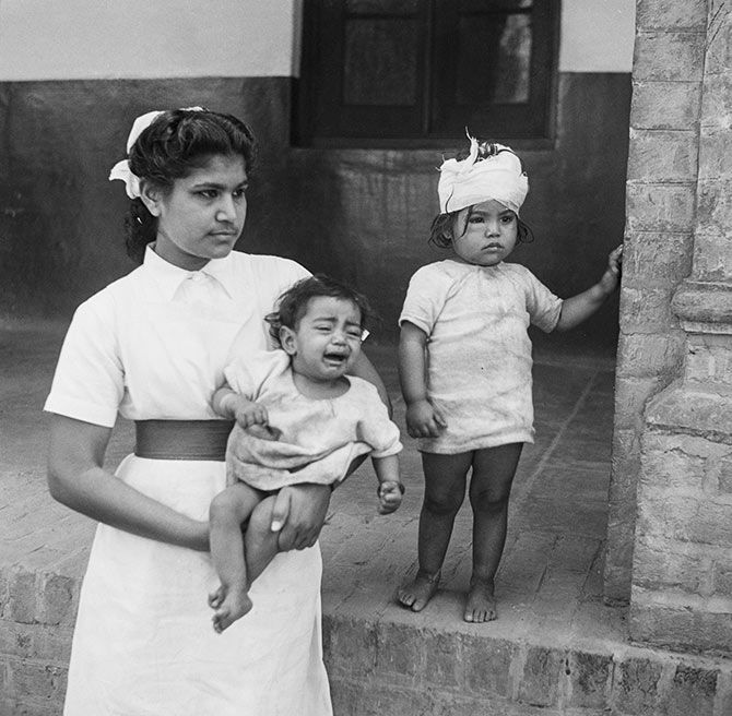 A nurse with two child victims of communal violence in Amritsar, Punjab, during the Partition of British India, March 194