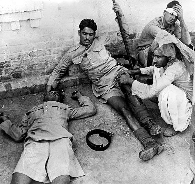 Three wounded Indian policemen receiving treatment following the riots in Lahore.