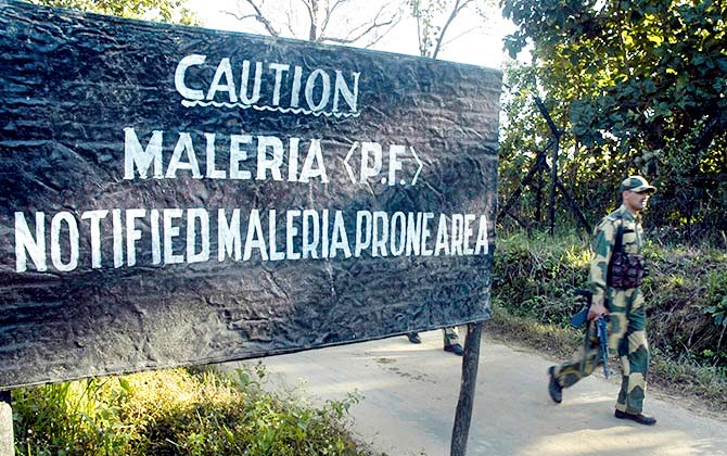 A Border Security Force (BSF) soldier walks past a warning sign in the remote Maharanicherra area, about 198 km (123 miles) southeast of Agartala, capital of India's northeastern state of Tripura December 11, 2007. Malaria poses a big threat to the troopers posted along the Tripura-Bangladesh border. Photo: Jayanta Dey/Reuters