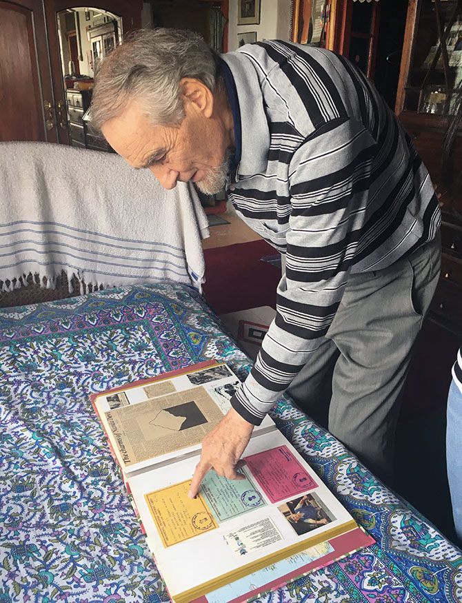 Bill Aitken shows his scrapbook of journeys