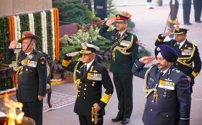Navy chief Admiral Sunil Lanba, centre, flanked by army chief General Bipin Rawat, left, and air force chief Air Chief Marshal Birender Singh Dhanoa at the Amar Jawan Jyoti on Navy Day, December 4, 2017. Photograph: SpokespersonMoD/Twitter