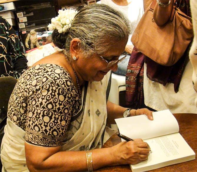 Sudha Murty signs a copy of her book, The Serpent's Revenge