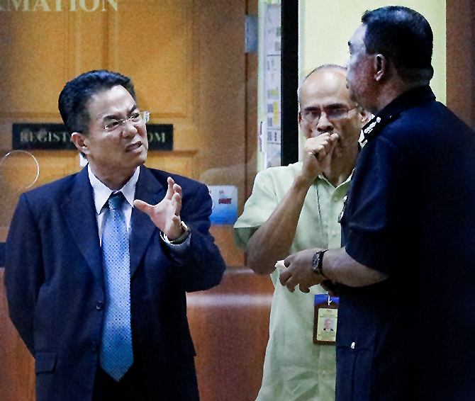 A North Korean official speaks with Malaysian police at the morgue at the Kuala Lumpur General Hospital where Kim Jong-nam's body was held for an autopsy, February 15, 2017. Photograph: Edgar Su/Reuters