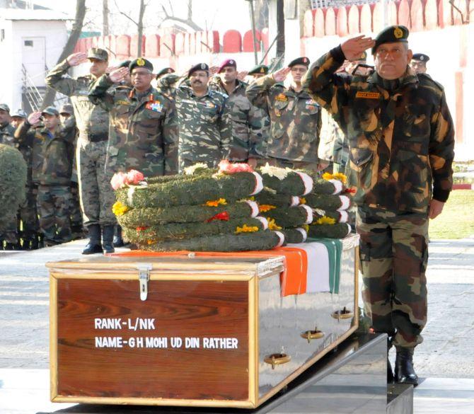 General Bipin Rawat, the chief of the army staff, pays homage to a soldier martyred in Kashmir. Photograph: Umar Ganie for Rediff.com