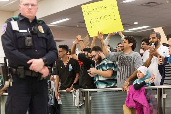 A man holds a welcome sign as people protest against the travel ban imposed by Trump's executive order at the Dallas/Fort Worth International Airport in Dallas, Texas, January 29, 2017. Photograph: Laura Buckman/Reuters