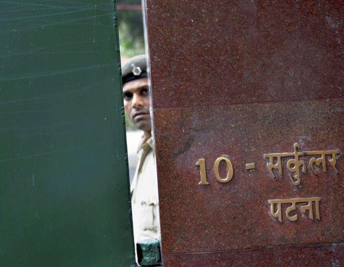 A policeman stands guard outside RJD chief Lalu Prasad’s 10, Circular Road, Patna, home during the CBI raids, July 7, 2017. Photograph: PTI Photo