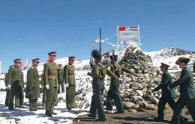 Indian Army officers, right, arrive for a meeting with the Chinese counterparts at the LAC