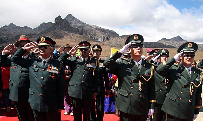 Indian and Chinese soldiers mark the 60th anniversary of the founding of the People's Republic of China at the India-China border in Arunachal
