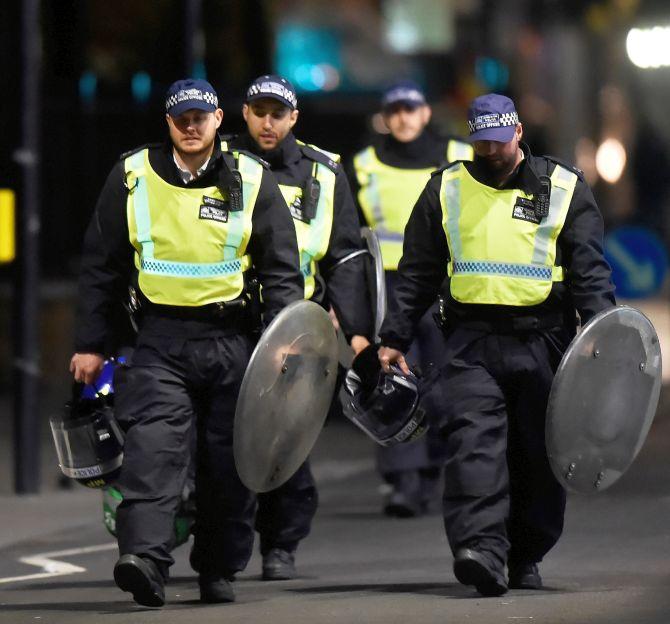 Metropolitan Police officers rush to London Bridge after receiving calls of a van ramming into pedestrians, in what they are now describing as a terrorist incident. Photograph: Hannah McKay/Reuters