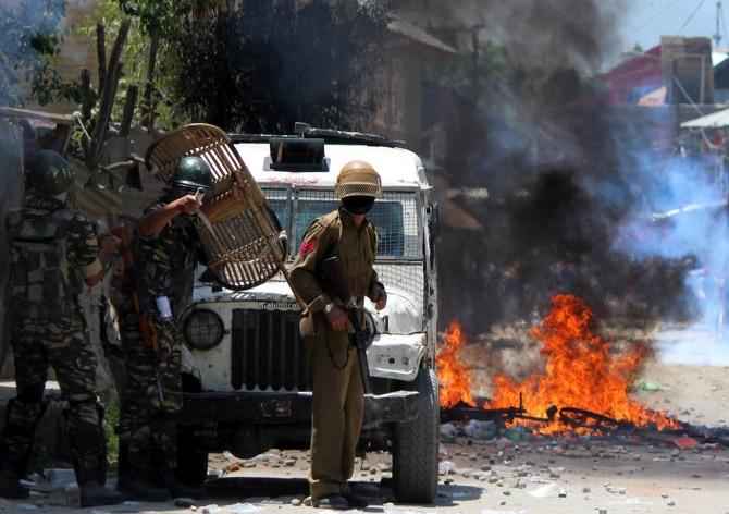 Soldiers at an encounter with Lashkar-e-Tayiba terrorists in Kashmir, June 16, 2017. The soldiers were simultaneously battling stone pelters trying to distract the army and let the terrorists escape. Photograph: Umar Ganie for Rediff.com