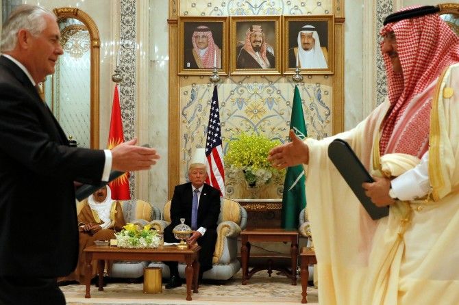 US President Donald Trump, centre, looks on as US Secretary of State Rex Tillerson, left, formerly Exxon's CEO, and Saudi Arabia's then crown prince Muhammad bin Nayef, right exchange a memorandum of understanding, a commitment by the Gulf states not to finance terrorist organisations, at the Gulf Cooperation Council leaders summit in Riyadh, Saudi Arabia, May 21, 2017. Photograph: Jonathan Ernst/Reuters